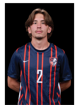A young man wearing a white and black jersey with the number 14 on it. Description generated by AI