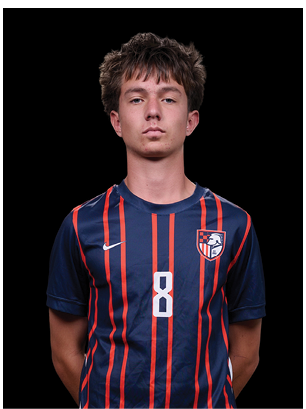 A young man wearing a white and black jersey with the number 14 on it. Description generated by AI
