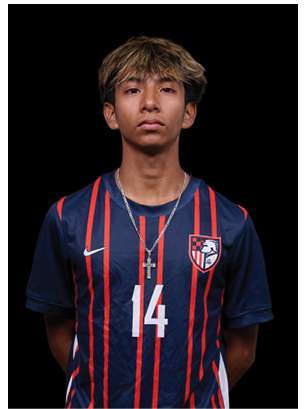 A young man wearing a white and black jersey with the number 14 on it. Description generated by AI