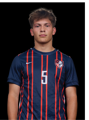 A young man wearing a white and black jersey with the number 14 on it. Description generated by AI