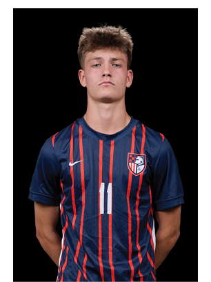 A young man wearing a white and black jersey with the number 14 on it. Description generated by AI