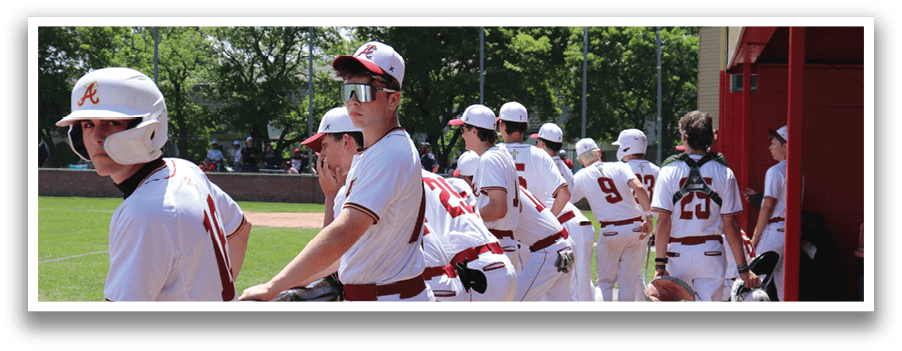 Baseball players wearing red and white uniforms. Description generated by AI