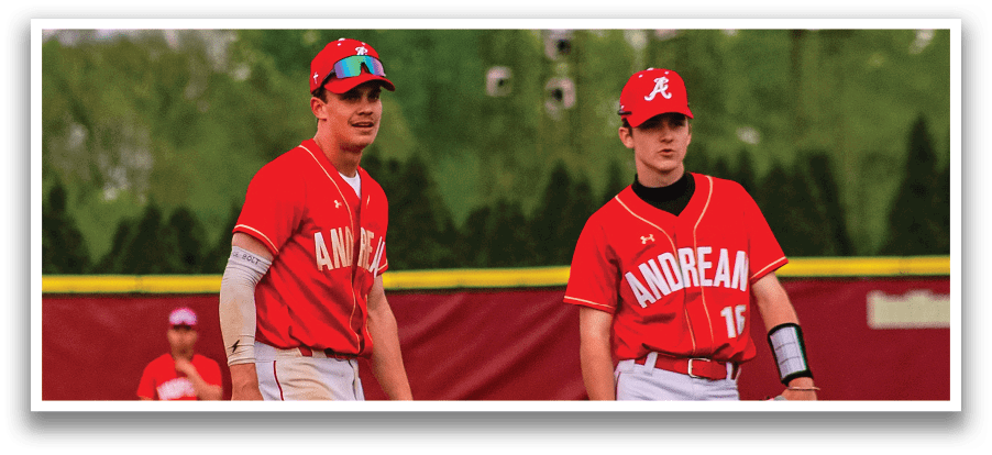 Two baseball players wearing red and white uniforms. Description generated by AI