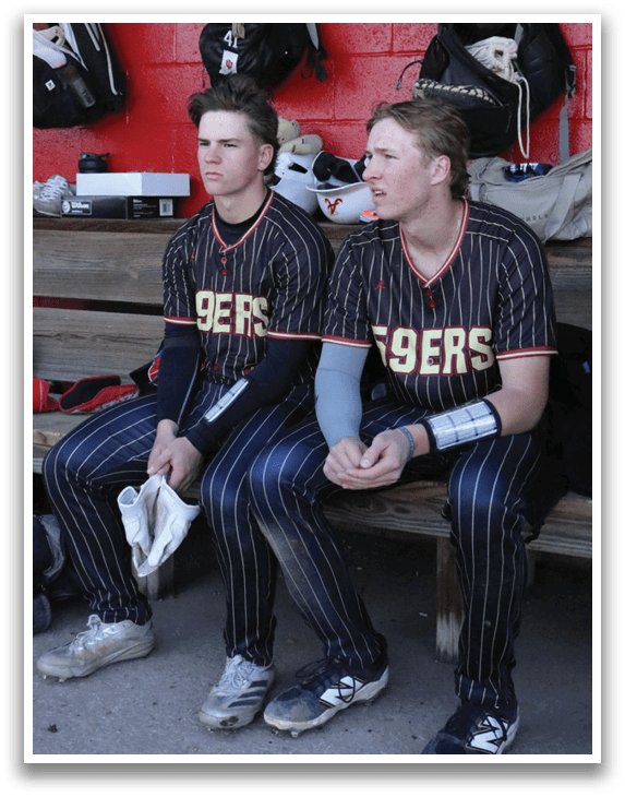 A baseball player in a white uniform is swinging a bat, preparing to hit a ball. AI generated content