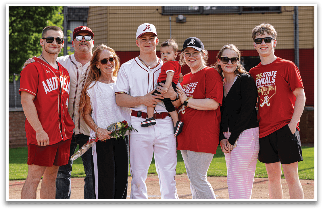 A group of people in red shirts and white pants standing on a baseball field. Description generated by AI