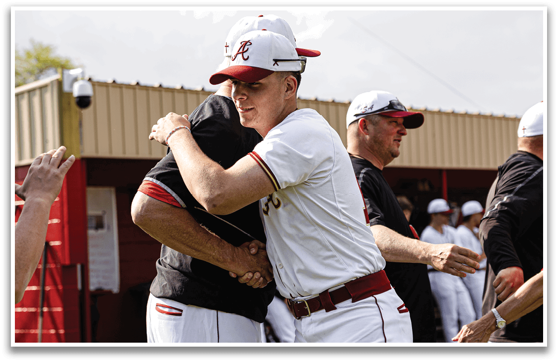 Two men wearing baseball uniforms hugging each other. Description generated by AI