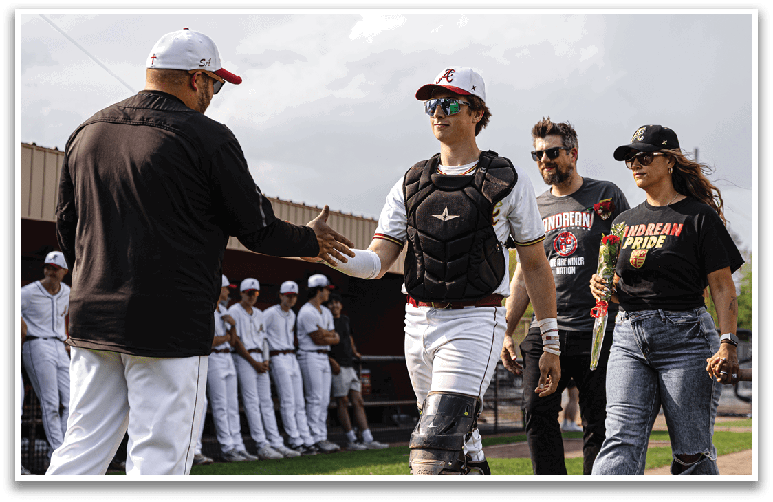 A man wearing a baseball glove shakes hands with another man. Description generated by AI