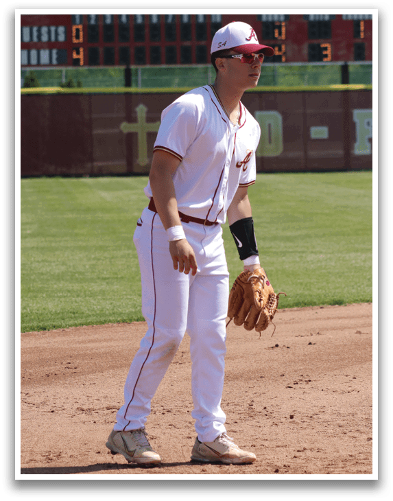 A baseball player wearing a white uniform and red socks. Description generated by AI
