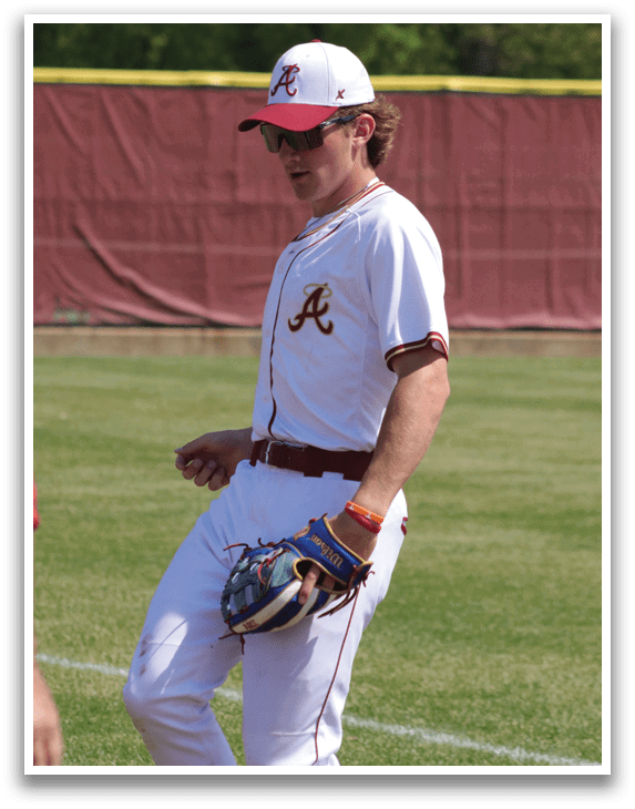 A baseball player wearing a red and white uniform. Description generated by AI