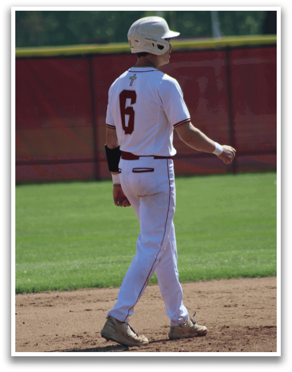 A baseball player wearing a white uniform with the number 6 on the back. Description generated by AI
