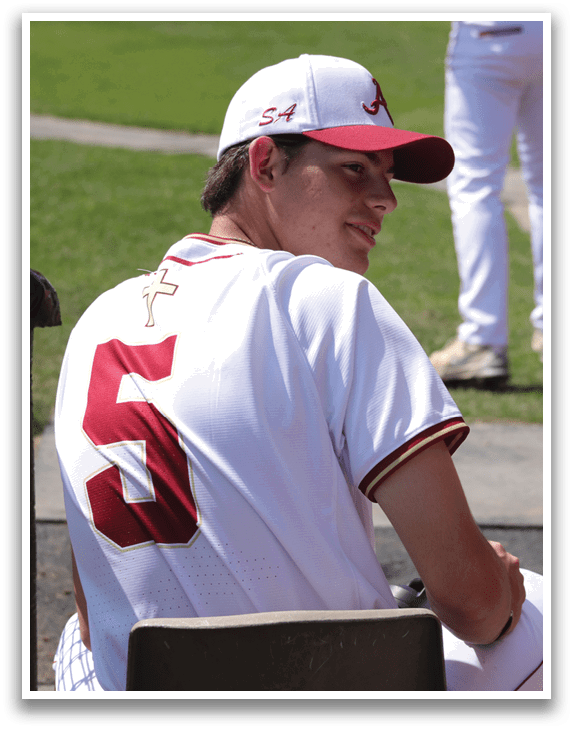 A baseball player wearing a white and red jersey with the number 5 on the back. Description generated by AI