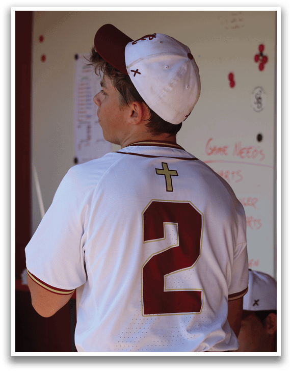 A baseball player wearing a white and red jersey with the number 2 on the back. Description generated by AI