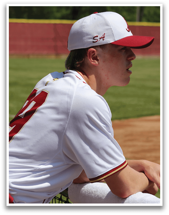 A baseball player wearing a white and red uniform with the number 32 on the back. Description generated by AI