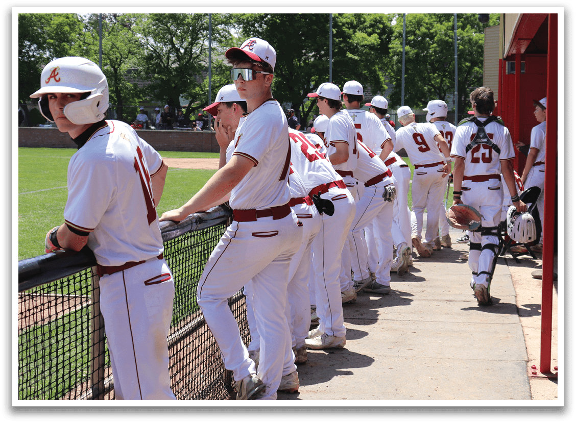Baseball players wearing red and white uniforms. Description generated by AI