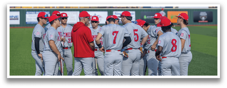 Baseball players wearing red hats and grey uniforms are gathered on a field. AI generated content