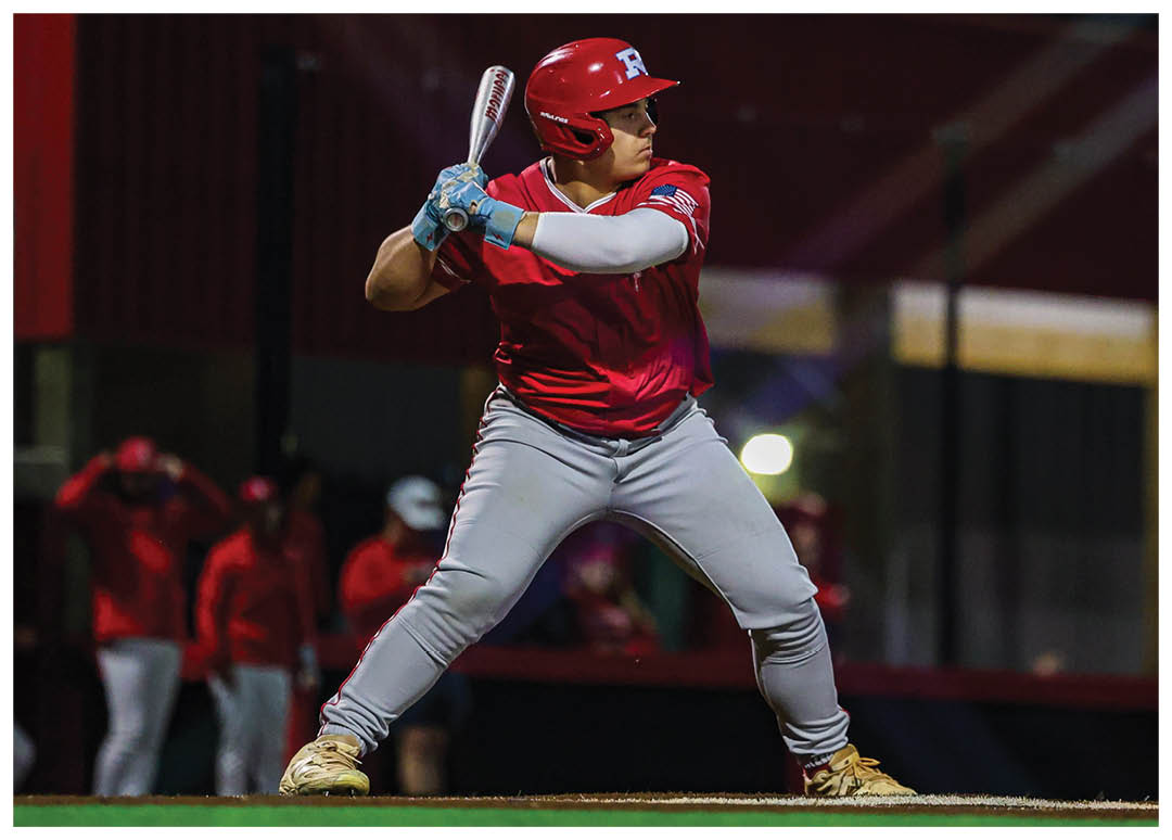 A baseball player in a red shirt and white pants is swinging a bat at a ball. AI generated content