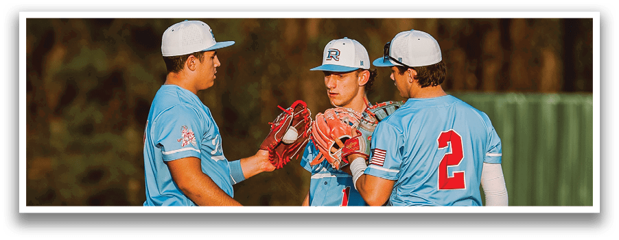 Three baseball players standing on a field. Description generated by AI