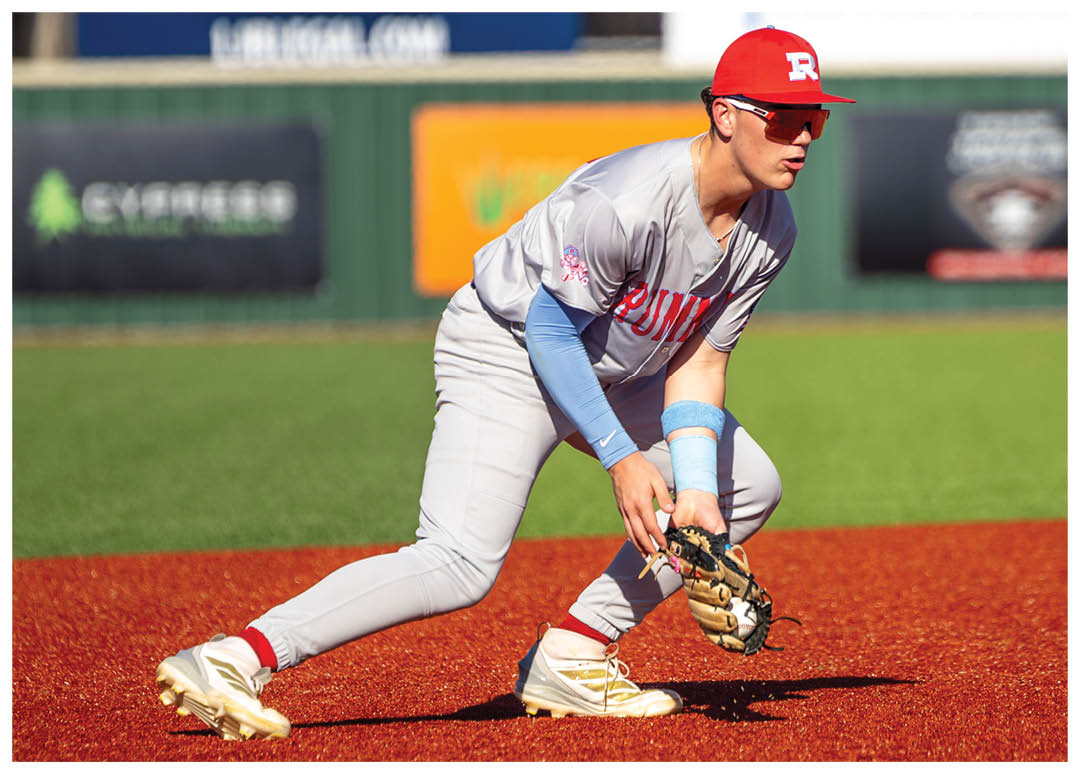 A baseball player in a grey uniform is kneeling on the field, holding a baseball glove. AI generated content