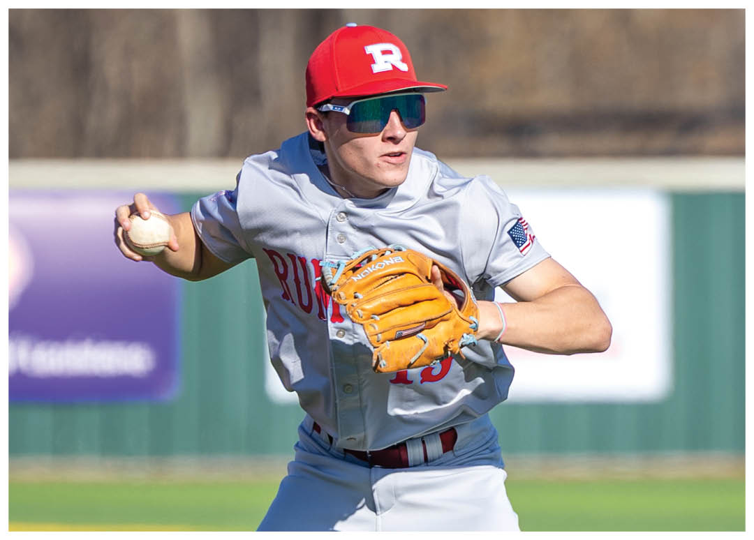 A baseball player in a grey uniform is standing on the field, holding a baseball glove. AI generated content