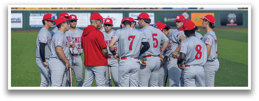 Baseball players wearing red hats and grey uniforms are gathered on a field. AI generated content