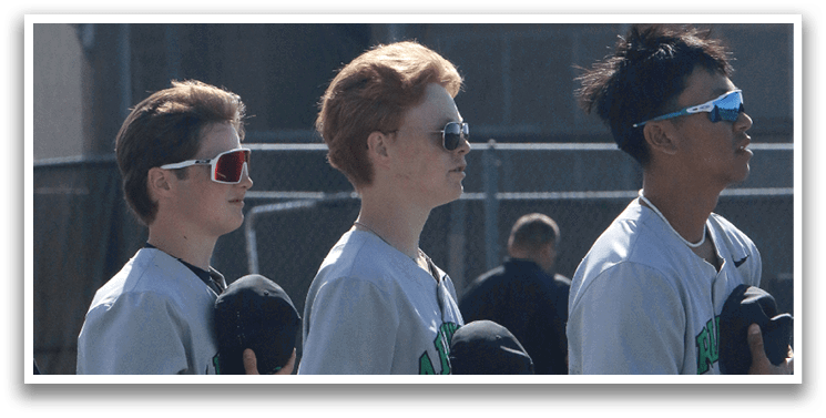 Three young men wearing baseball uniforms stand on a field, holding baseball bats. AI generated content