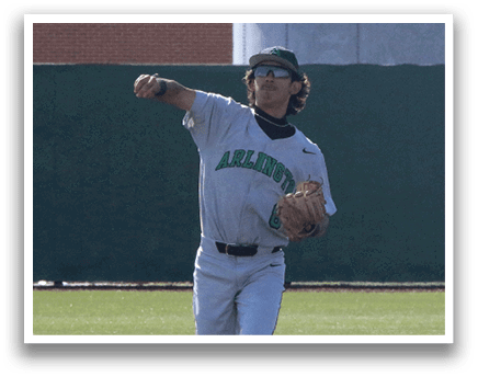 A baseball player in a grey uniform is standing on the field, holding a baseball glove and pointing towards the sky. AI generated content
