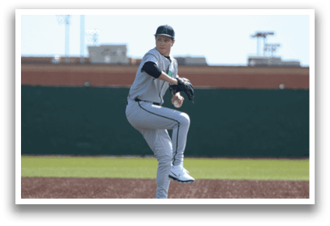 A baseball player in a grey uniform is pitching a ball on a field. AI generated content