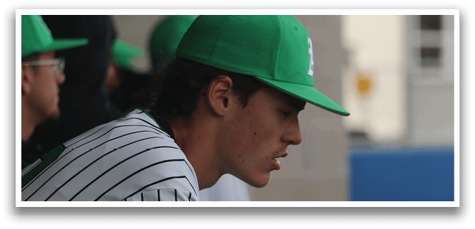 A baseball player wearing a green hat and a white and black striped shirt sits on a bench. AI generated content
