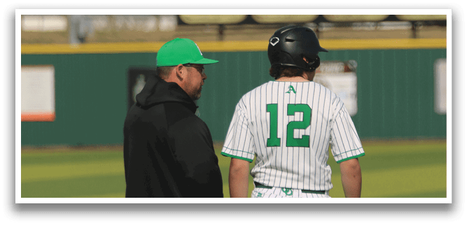 Two men are standing on a baseball field, one of them wearing a green hat. AI generated content