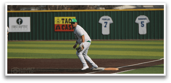 A baseball player in a white uniform is swinging a bat on a baseball field. AI generated content