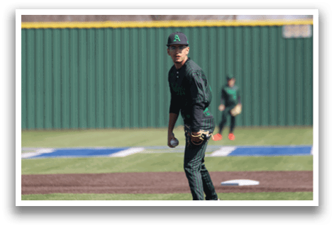 A baseball player in a green and black uniform is standing on the pitcher's mound, preparing to throw the ball. AI generated content