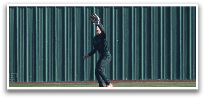 A person wearing a baseball glove is standing on a baseball field. AI generated content