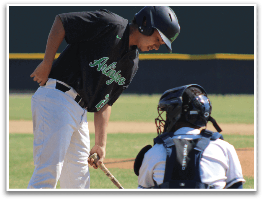 A baseball player is holding a bat, getting ready to hit the ball. The catcher is positioned behind him, wearing a baseball glove. AI generated content