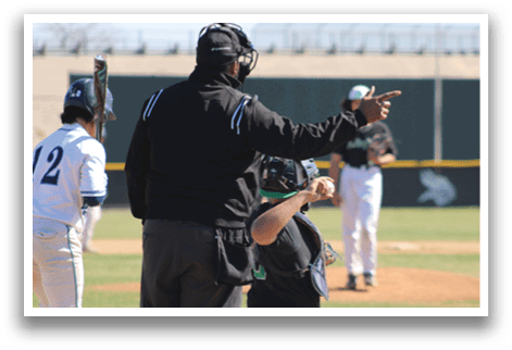 A baseball game is in progress with a man wearing a black shirt and hat standing on the field. He is pointing his finger towards the batter, likely giving instructions or calling out a play. Another person is standing nearby, possibly a teammate or an opponent. The scene captures the intensity and focus of the game. AI generated content
