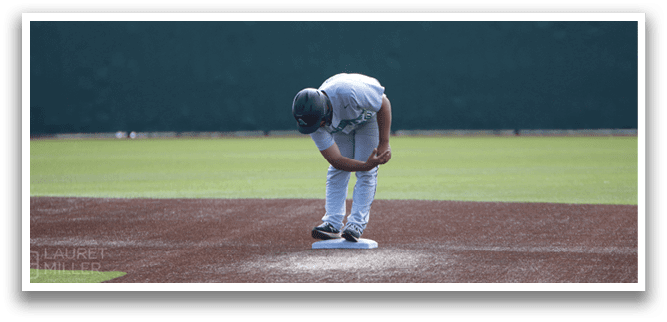 A baseball player bends over on the field, wearing a baseball glove. AI generated content