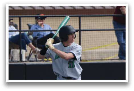 A baseball player is at bat, holding a bat and preparing to swing. The player is wearing a grey uniform and is surrounded by a crowd of people watching the game. AI generated content
