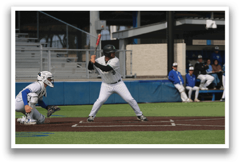 A baseball player is at bat, holding a bat and preparing to swing. AI generated content
