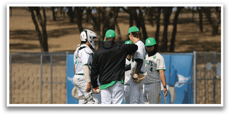 A group of baseball players wearing green and white uniforms are standing on a field. AI generated content