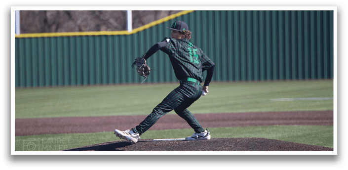 A baseball player in a green and black uniform is pitching a ball on a field. AI generated content