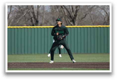 A baseball player in a green and black uniform is standing on the field, holding a baseball glove. AI generated content