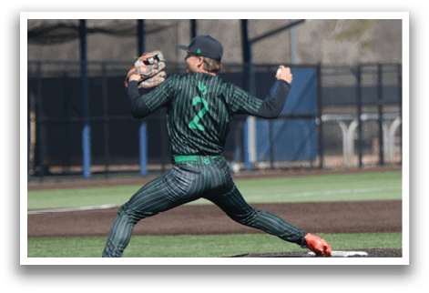 A baseball player in a green and black uniform is in the process of throwing a pitch. AI generated content