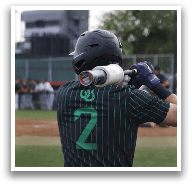 A baseball player wearing a green and black shirt with the number 2 on it. Description generated by AI