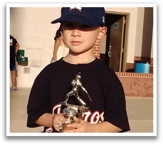 A young boy holding a trophy. Description generated by AI