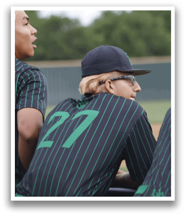 A person wearing a green and black shirt. Description generated by AI