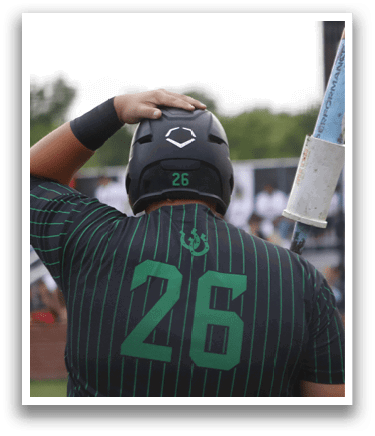 A baseball player wearing a green shirt with the number 26 on it. Description generated by AI