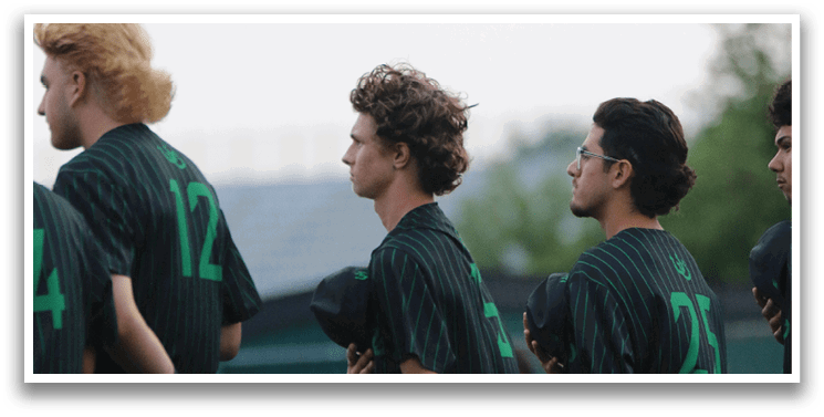 A group of men wearing green and white uniforms. Description generated by AI