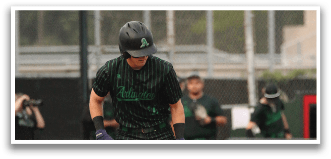 A baseball player is holding a bat and standing on home plate. Description generated by AI
