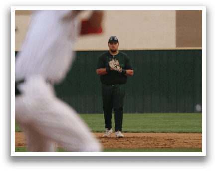 A baseball player is holding a bat and getting ready to swing. Description generated by AI