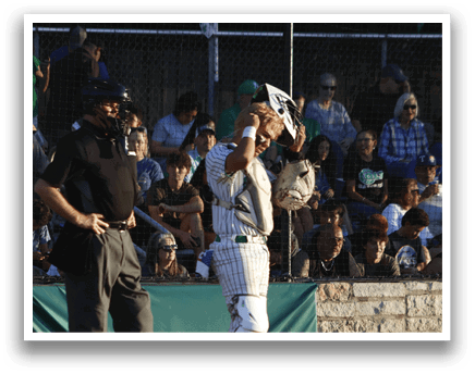 A group of baseball players wearing white uniforms. Description generated by AI