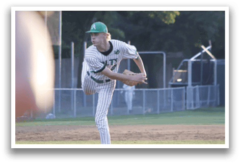 A baseball player in a green and white uniform is pitching a ball. Description generated by AI